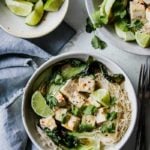 30-Minute Lemongrass Coconut Tofu Noodle Bowls styled in a white bowl on a blue surface.