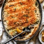 Spring Leek and Mushroom Gratin styled in a cast iron oval baking dish.
