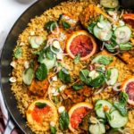 Turmeric-glaze salmon in a skillet with bulgur