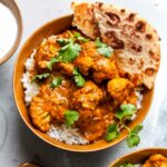 Vegetarian Butter Cauliflower recipe served over basmati rice with yogurt and naan
