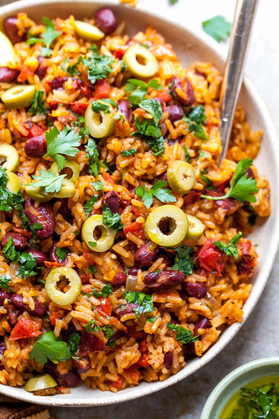 Spanish Rice and Beans served with olives and parsley oil