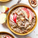 Slow Cooker Steel Cut Oatmeal topped with apple slices