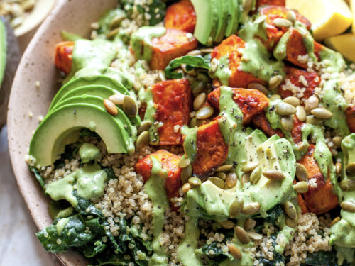 Vibrant quinoa bowl loaded with roasted sweet potatoes, massaged kale, avocado, and turmeric dressing for nutrient-dense immune support