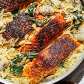 Spinach Artichoke Salmon styled in a saut&eacute; pan.