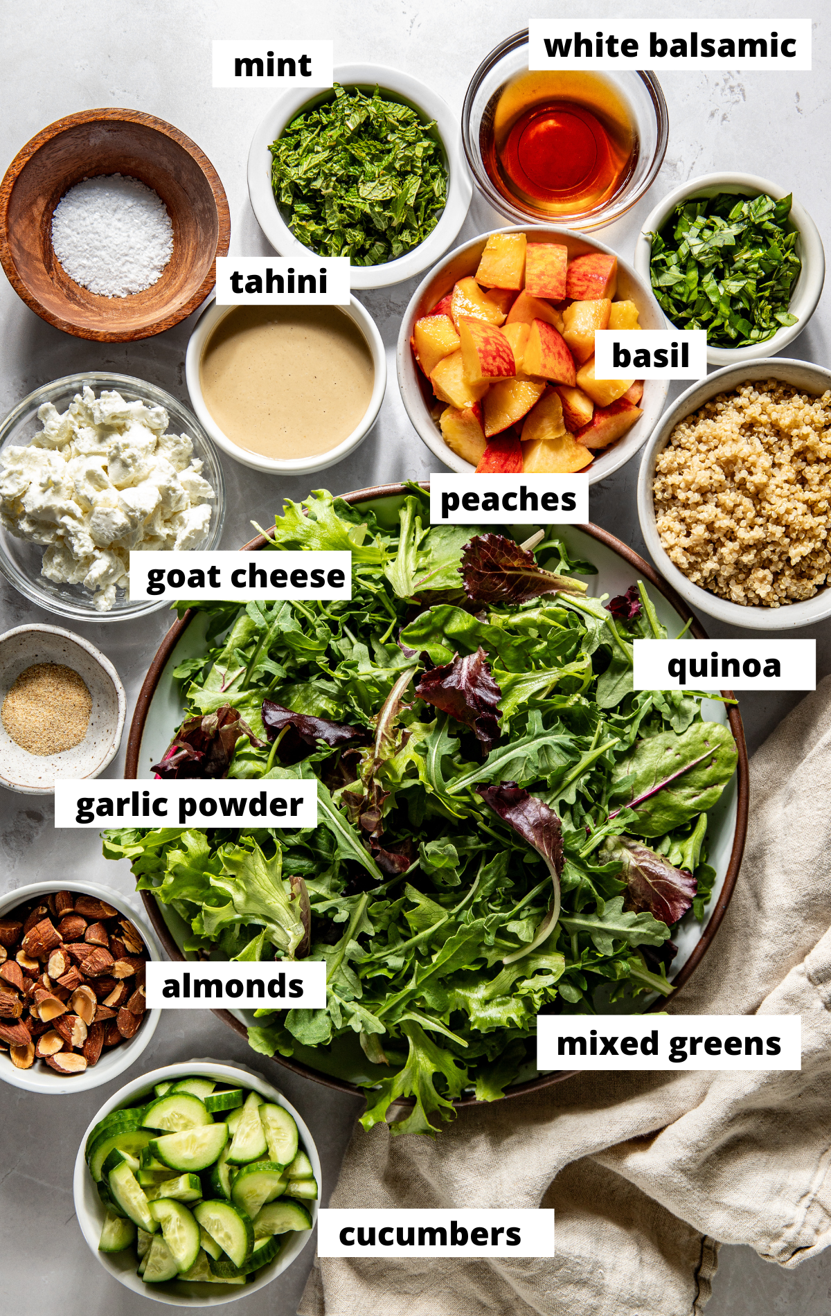 Recipe ingredients in separate bowls arranged on a white surface with labels.