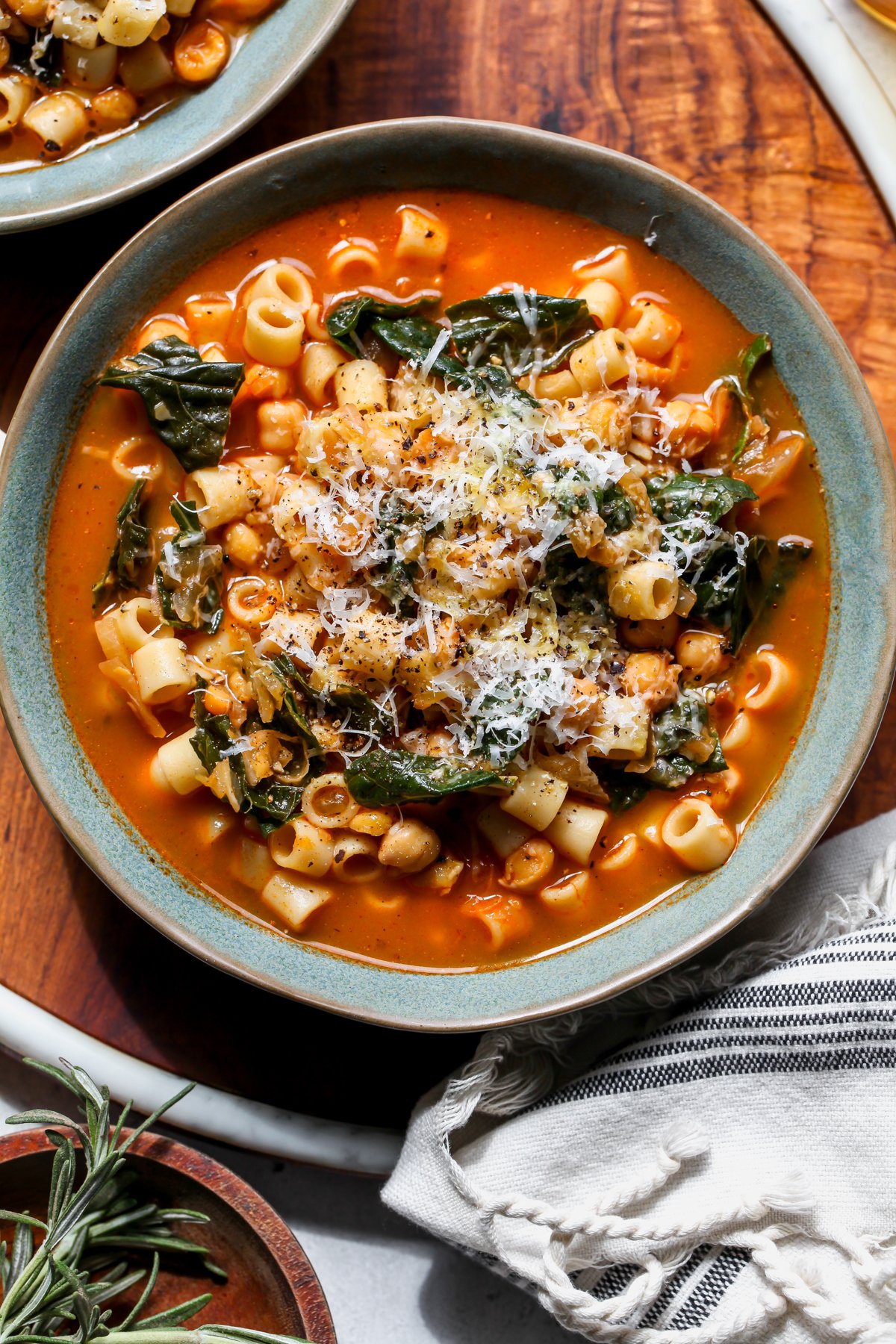 A blue bowl filled with Italian pasta and chickpea stew.