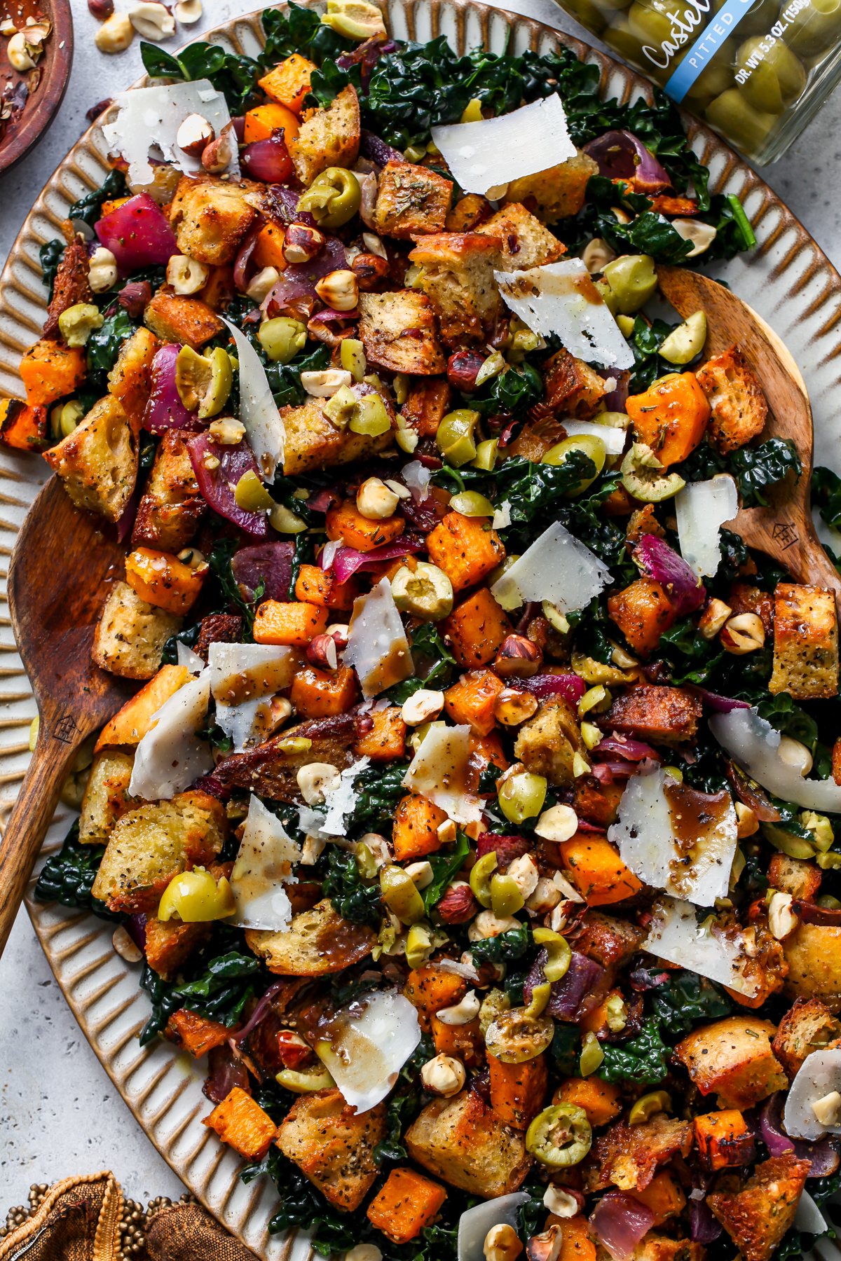 Autumn Panzanella Salad styled on a large scalloped serving platter.