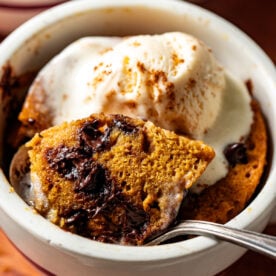 A bite of cake being lifted with a silver spoon to show inside texture of cake.