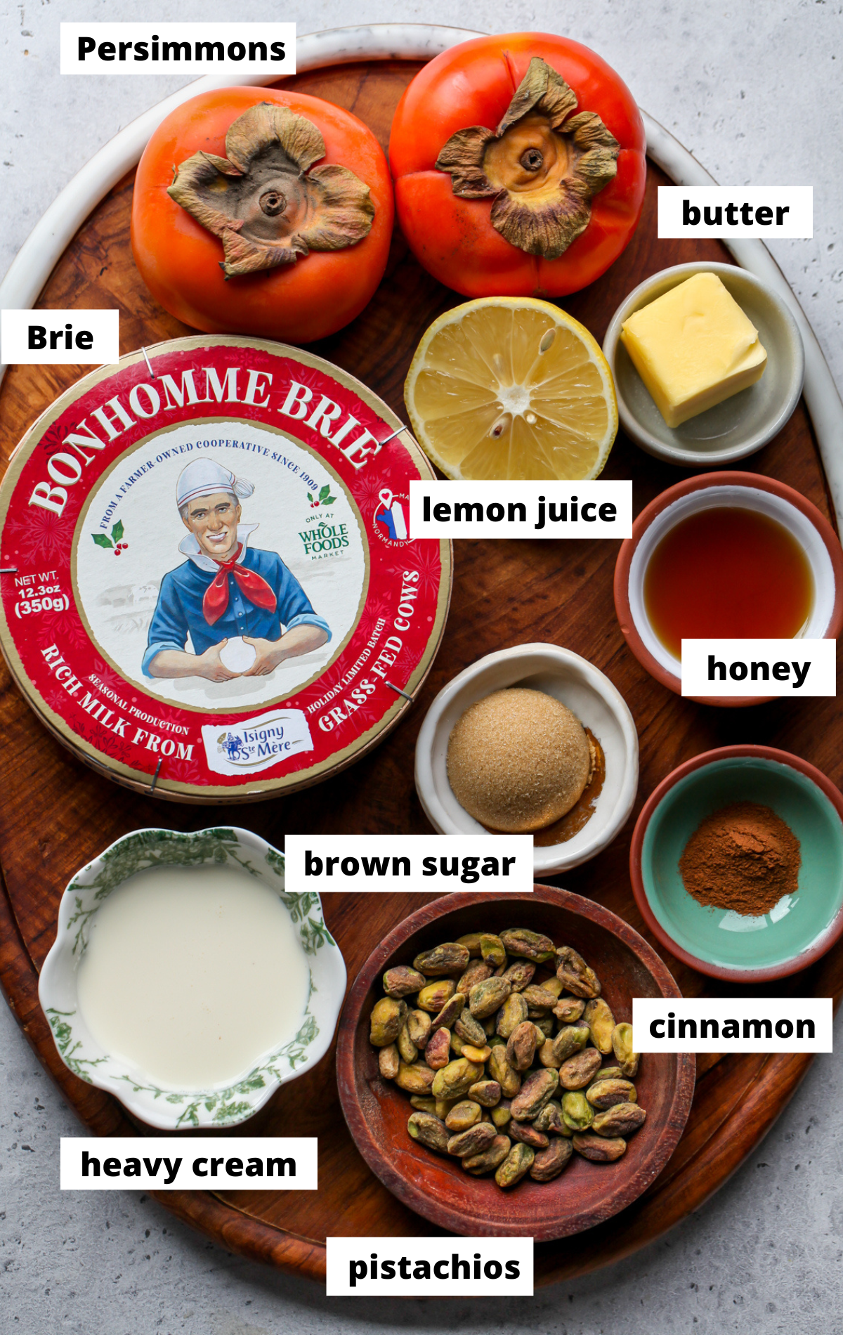 Recipe ingredients arranged on a wooden platter with labels.