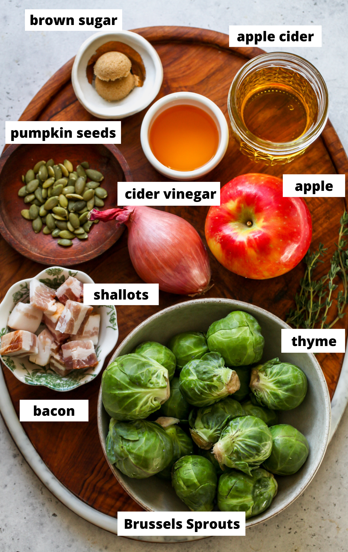 Recipe ingredients arranged on a wooden platter with labels.
