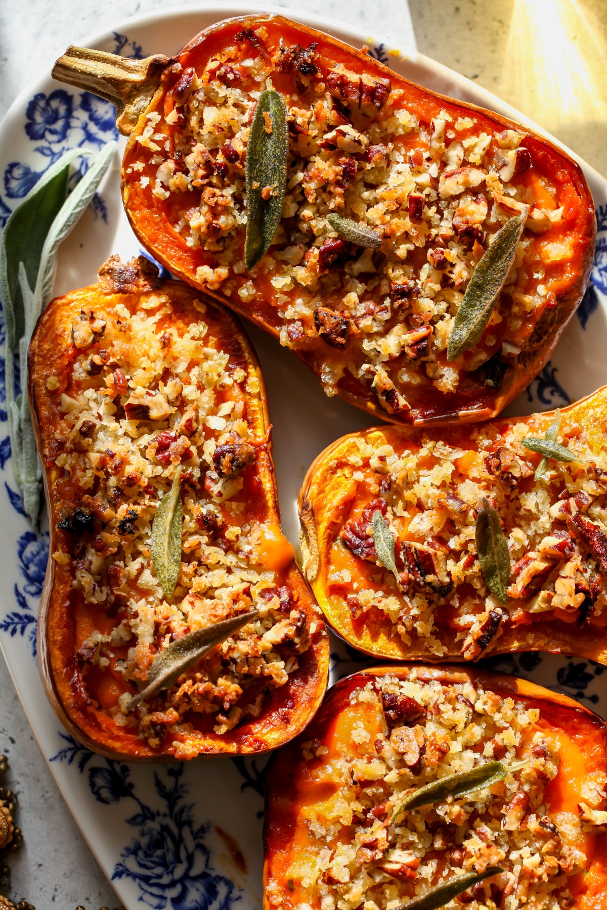 Twice-Baked Honeynut Squash assembled on a white and blue floral serving platter.