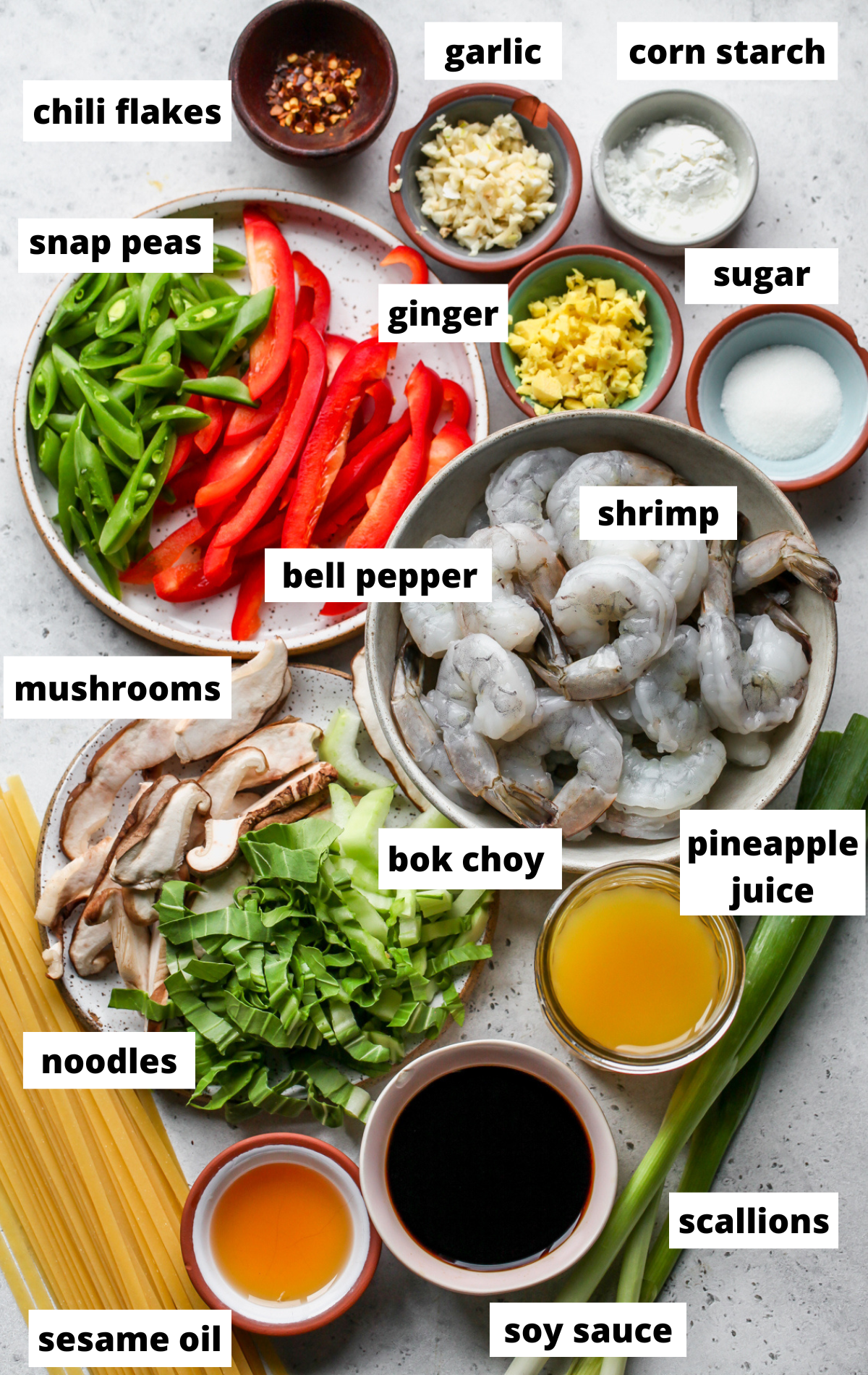 Recipe ingredients in separate bowls on a gray surface with labels.