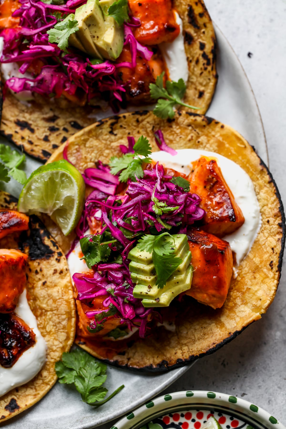 Honey-Chipotle Salmon Tacos assembled on a round white platter.