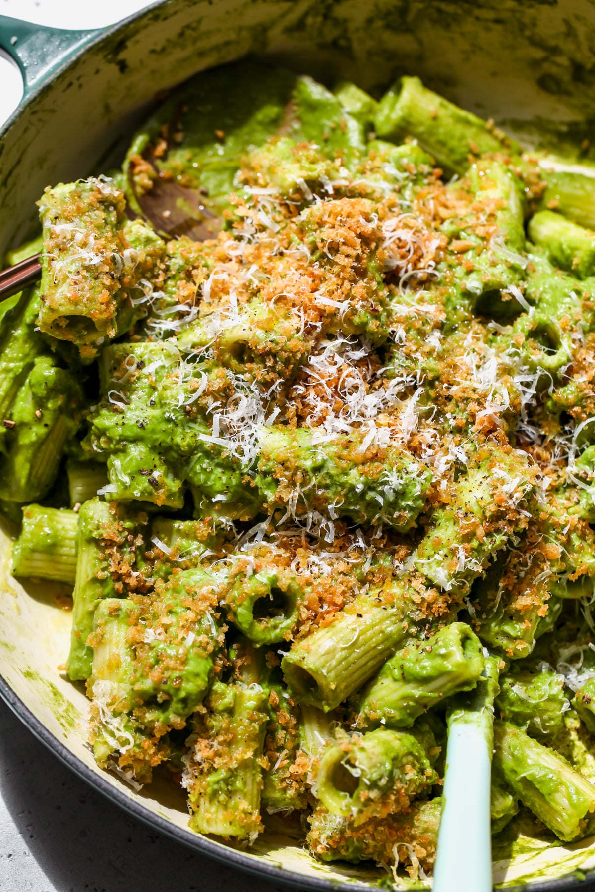 Creamy Caramelized Leek Pasta topped with anchovy breadcrumbs and grated Parmesan in a sauté pan.