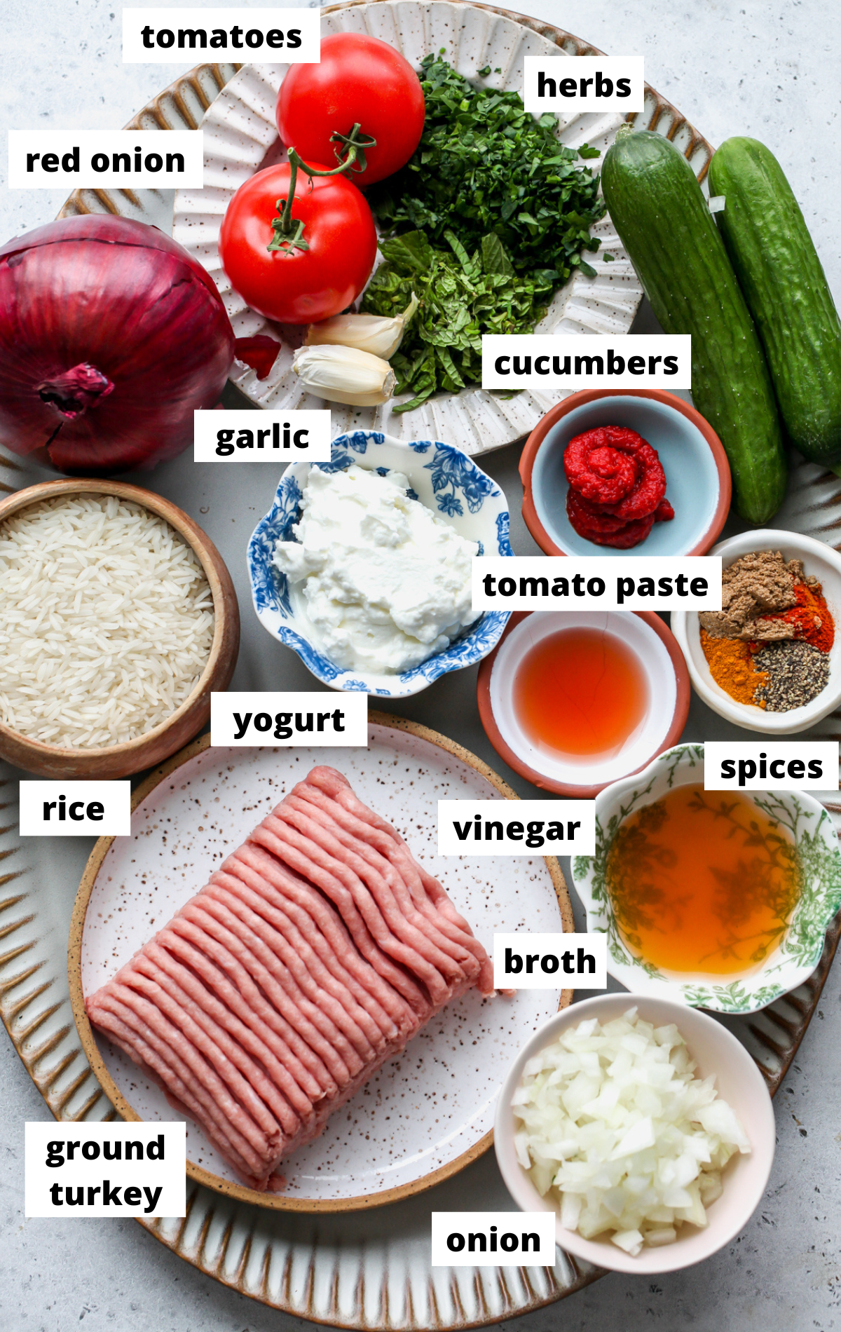 Recipe ingredients in separate bowls arranged on a large scalloped platter with labels.