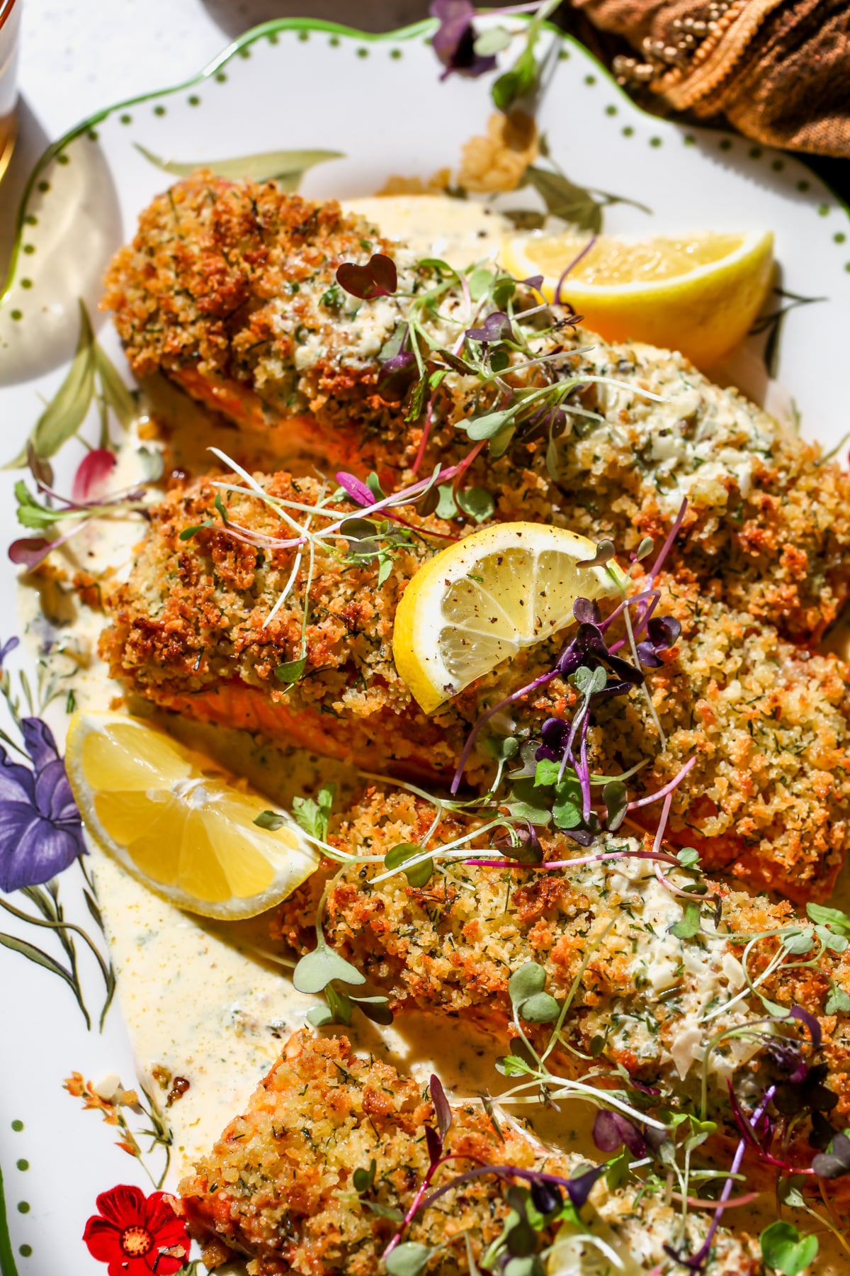 Panko Crusted Salmon with Creamy Dill Sauce styled on a white floral platter.