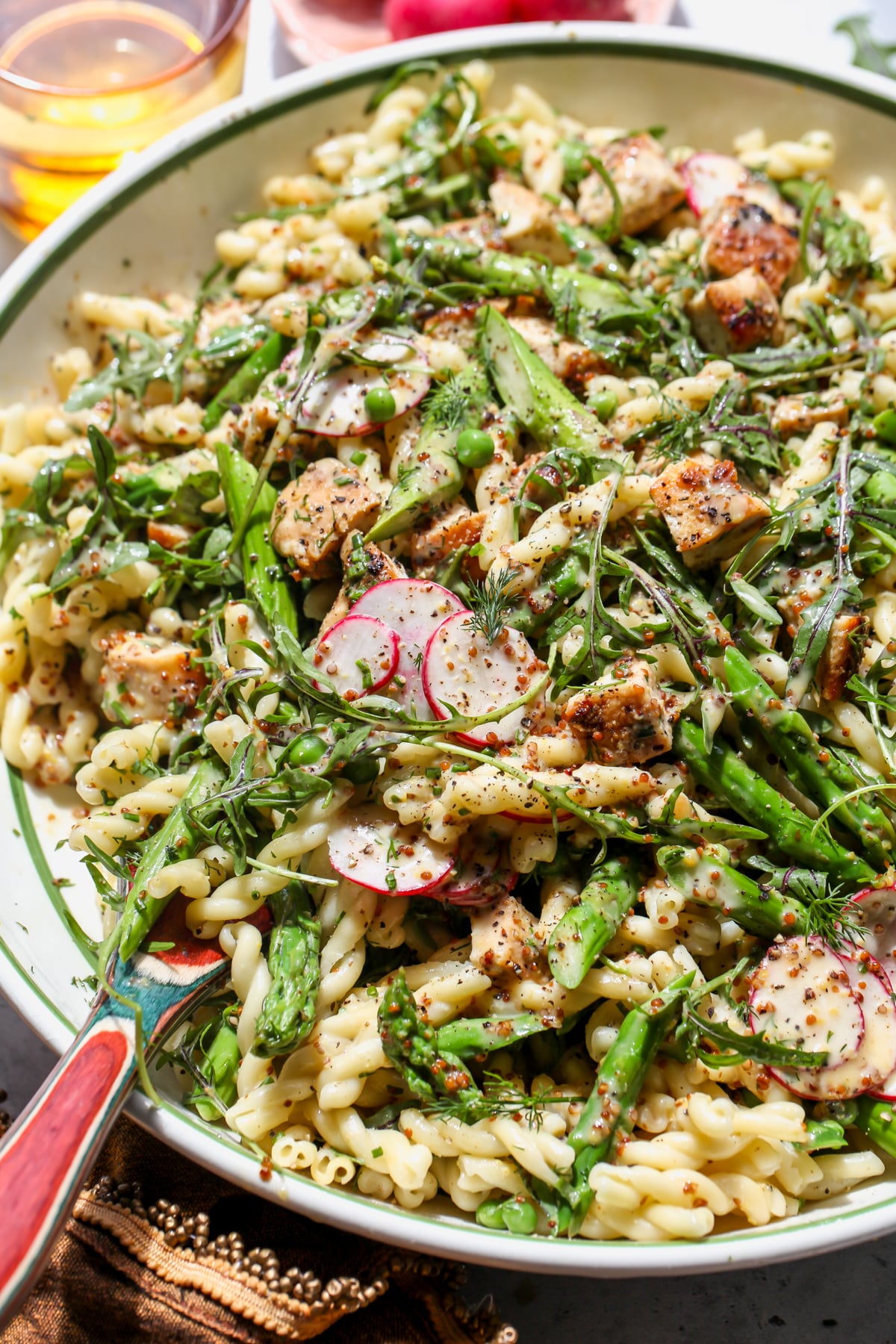 Honey mustard pasta salad after being mixed in a large mixing bowl.