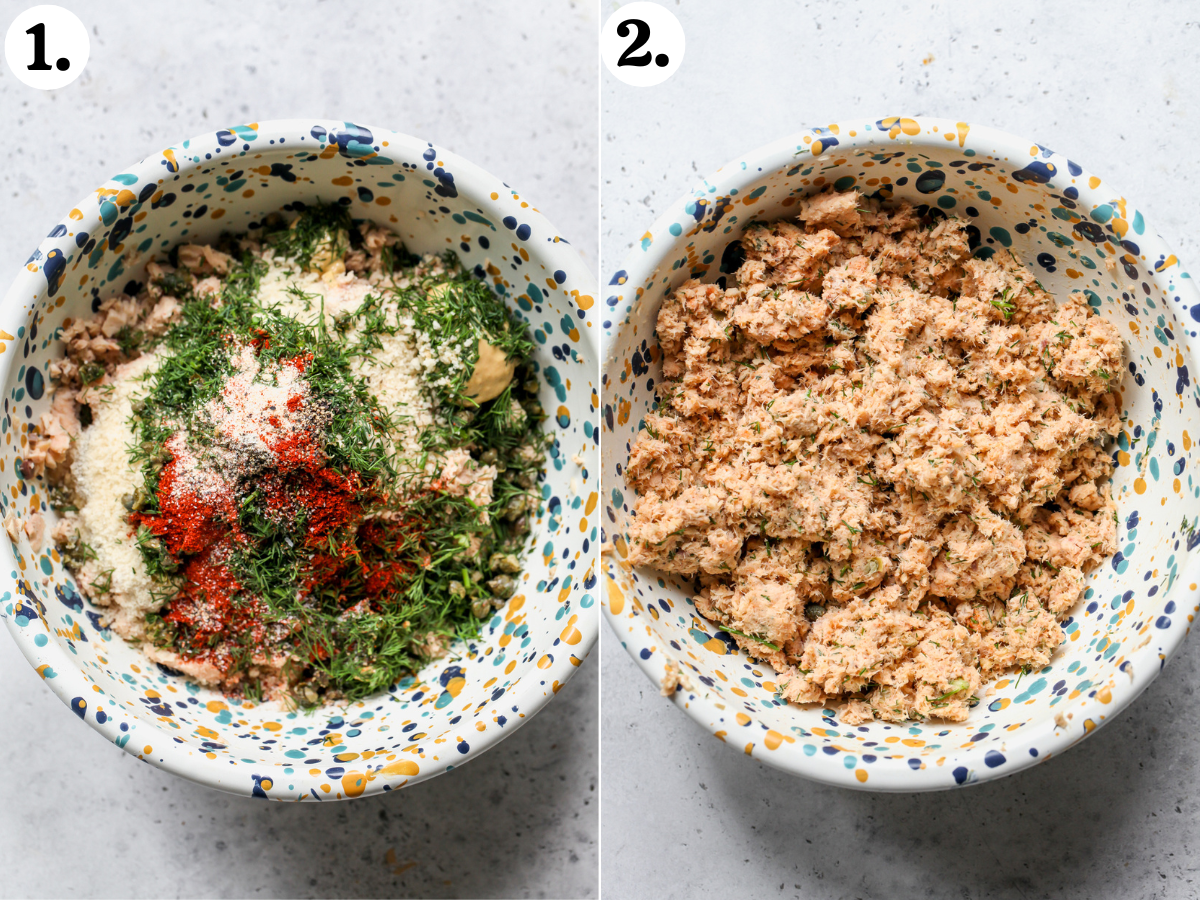 Canned salmon, panko, eggs, spices, and herbs being mixed together in a speckled mixing bowl.