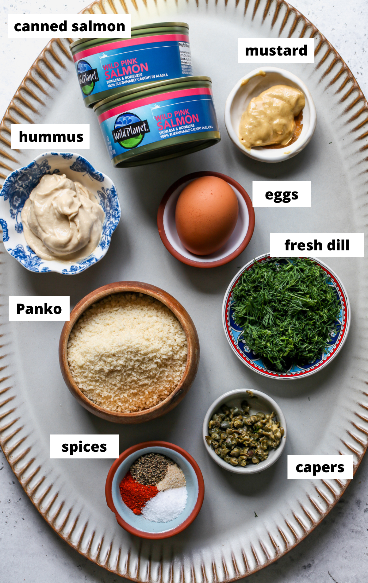 Recipe ingredients arranged on a large scalloped platter with labels.