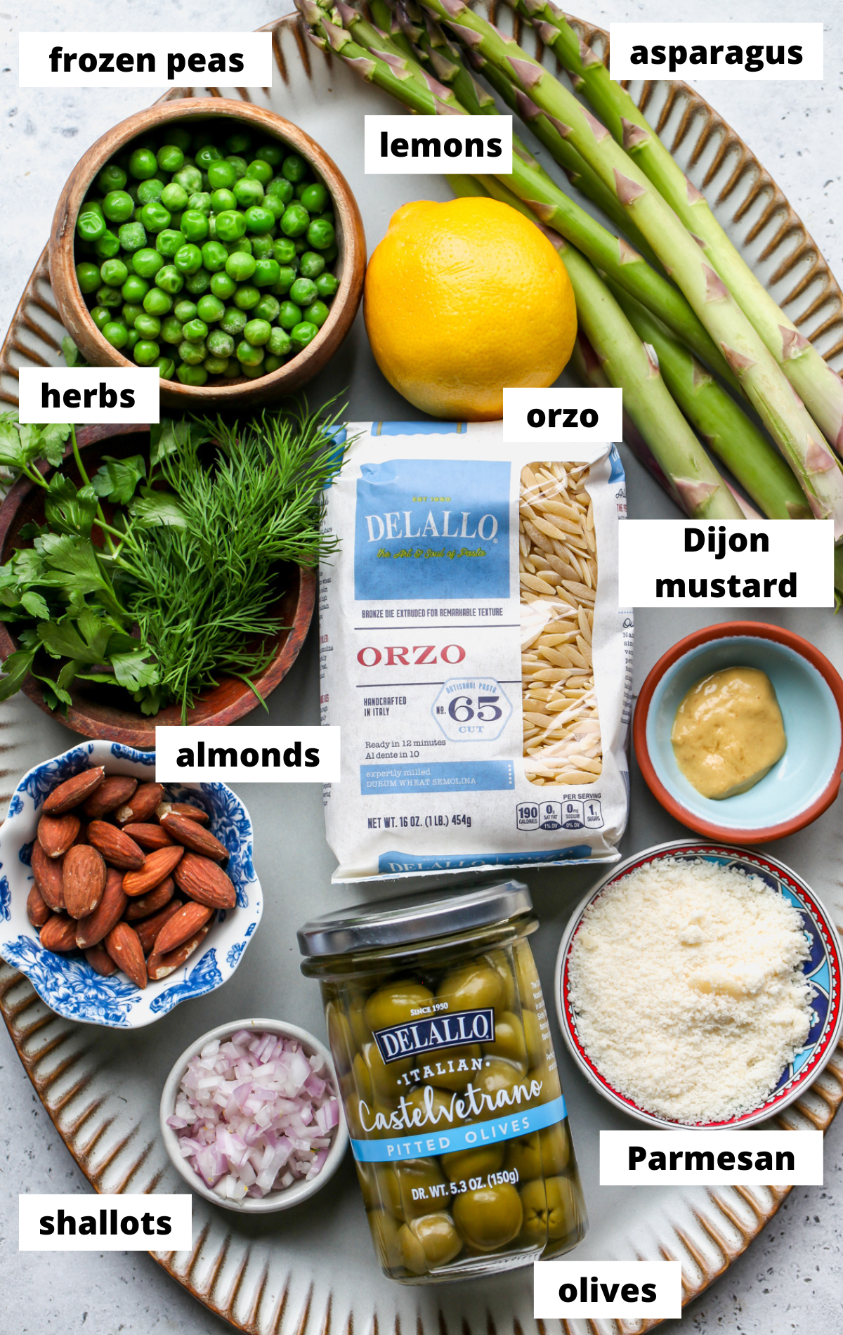 Recipe ingredients arranged on a large scalloped platter with labels.