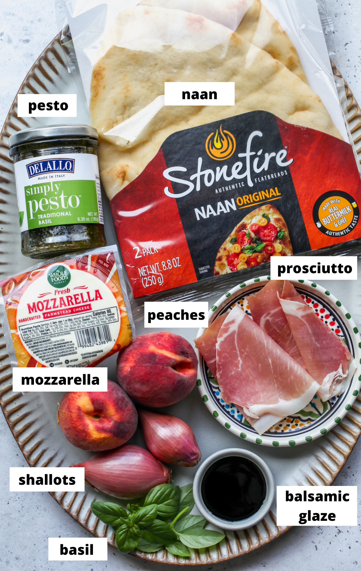 Recipe ingredients arranged on a large scalloped platter with labels.