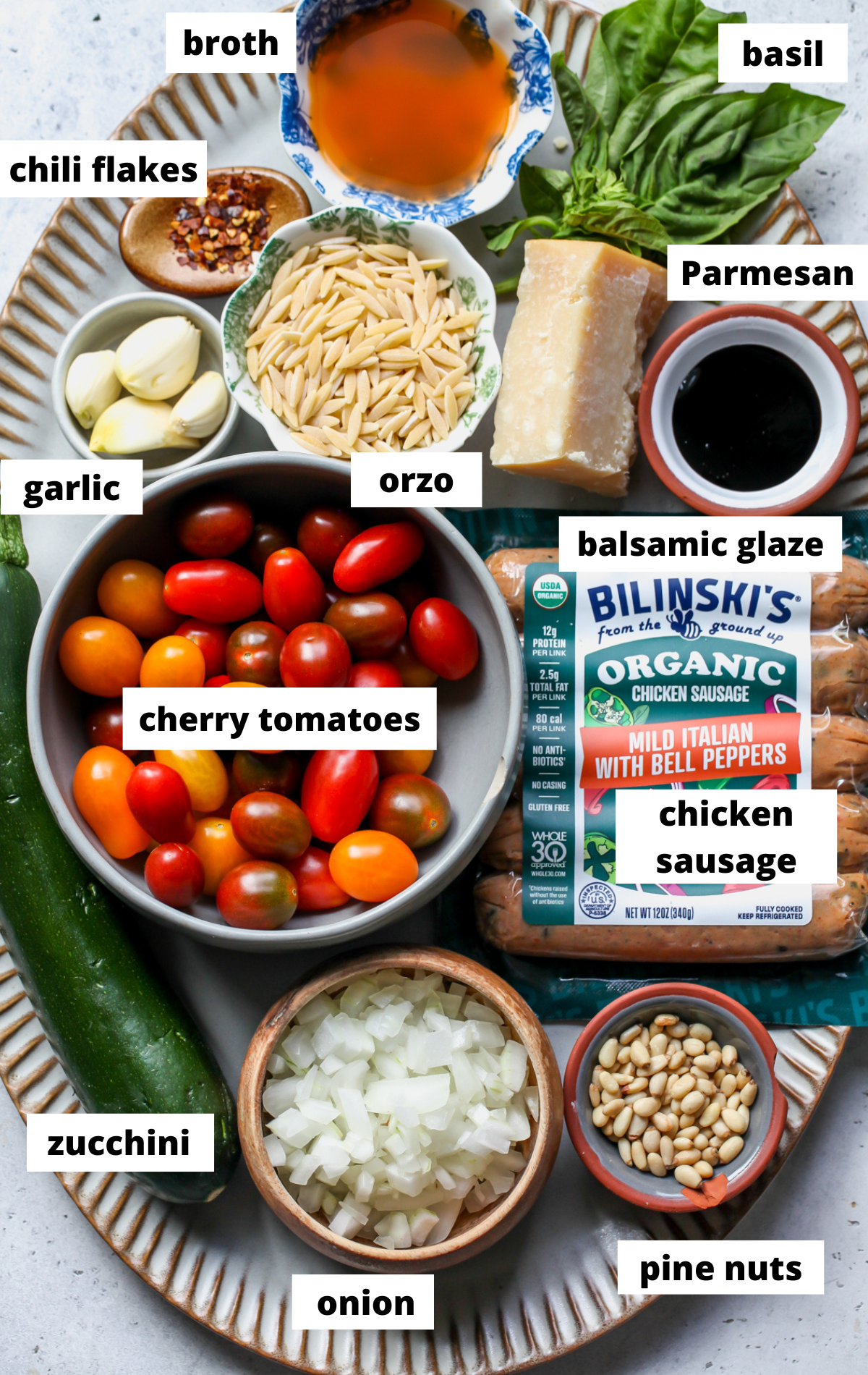 Recipe ingredients arranged on a large scalloped platter with labels.