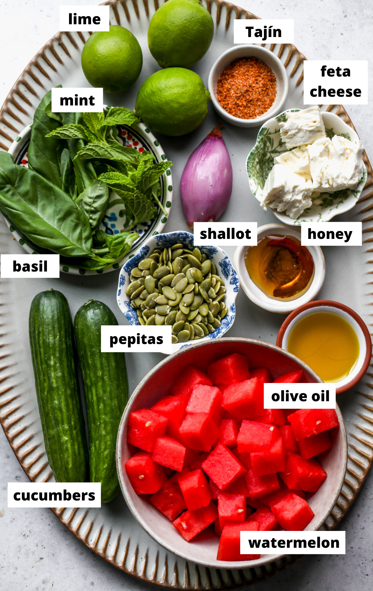 Recipe ingredients arranged on a large scalloped platter with labels.