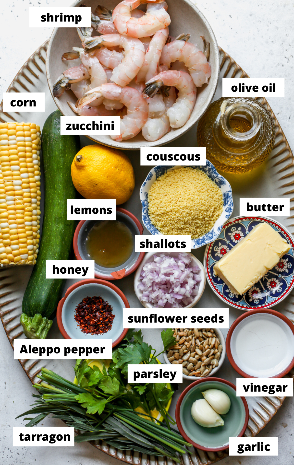 Recipe ingredients arranged on a large scalloped platter with labels.