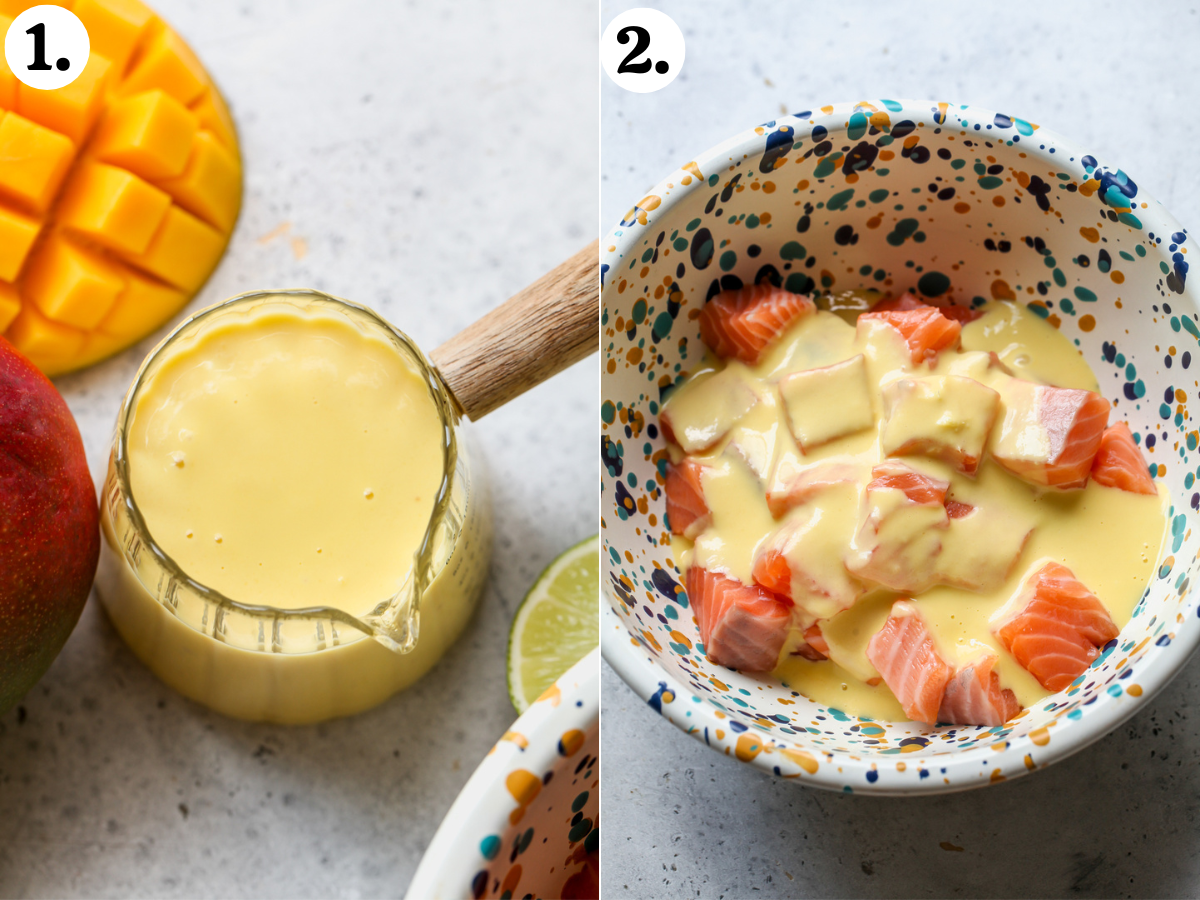 Mango-miso sauce in a glass jar being poured over cubes of salmon in a speckled mixing bowl.