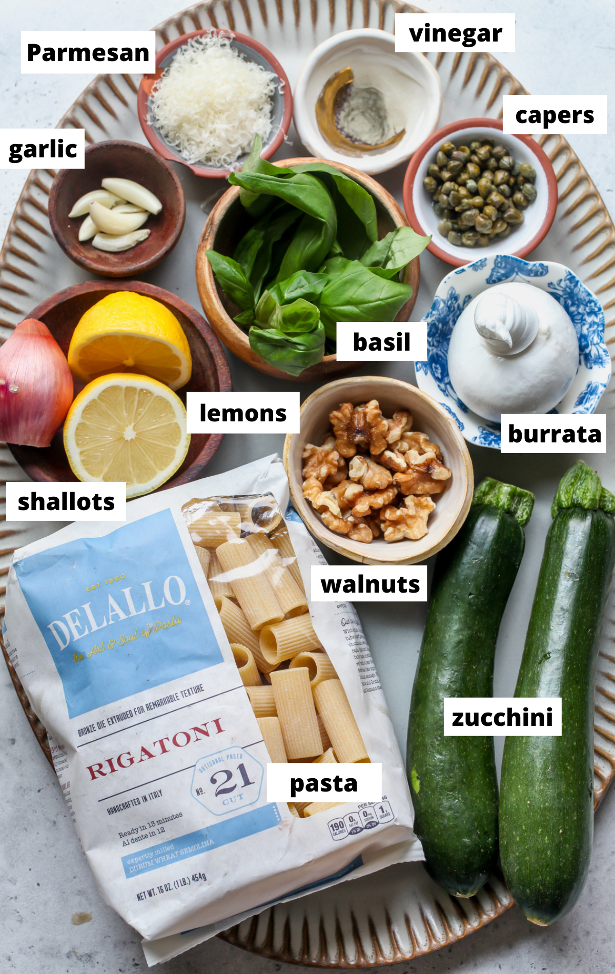 Recipe ingredients arranged on a large scalloped platter with labels.