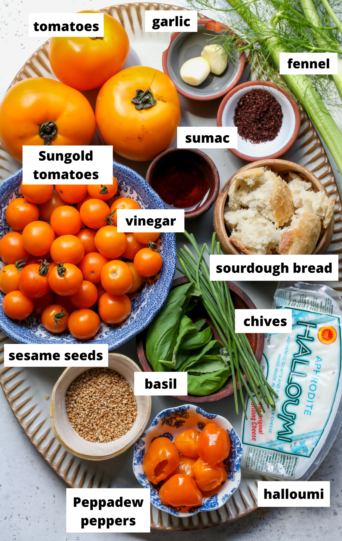 Recipe ingredients arranged on a large scalloped platter with labels.