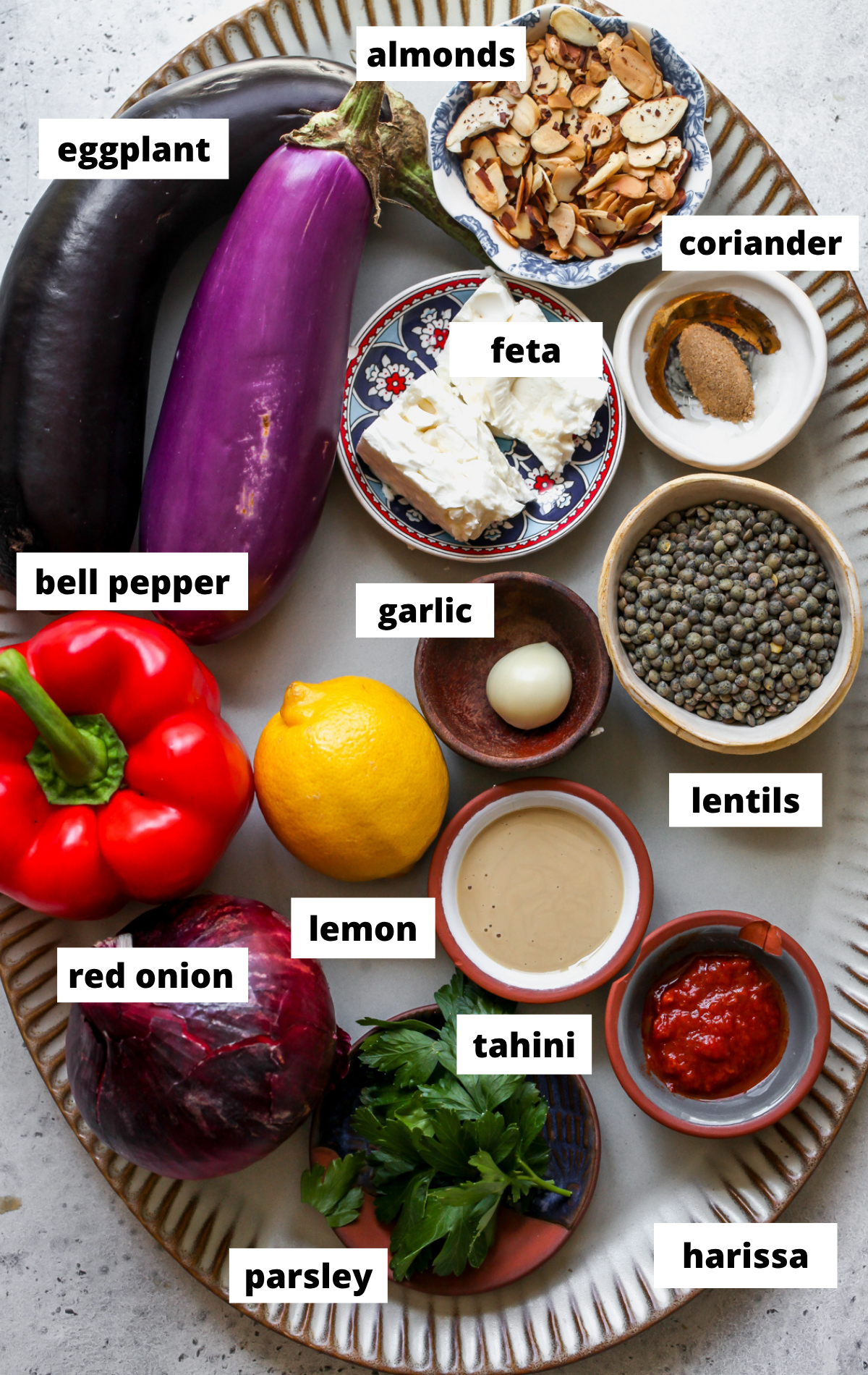 Recipe ingredients arranged on a large scalloped platter with labels.