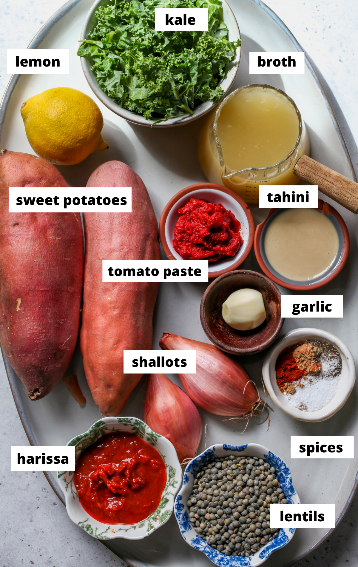 Recipe ingredients arranged on a large scalloped platter with labels.