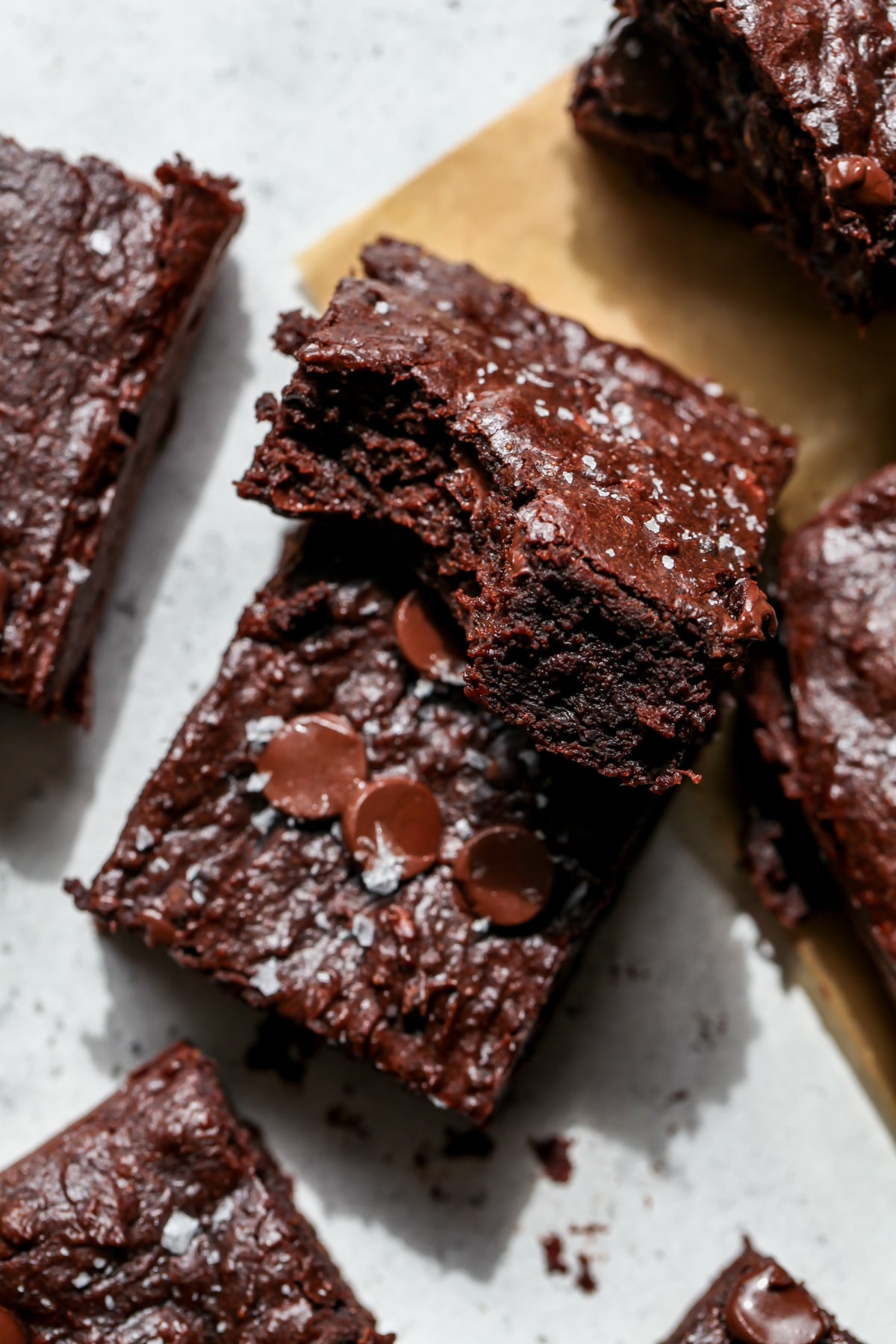 One brownie stacked on top of another at an angle to show the inside texture.