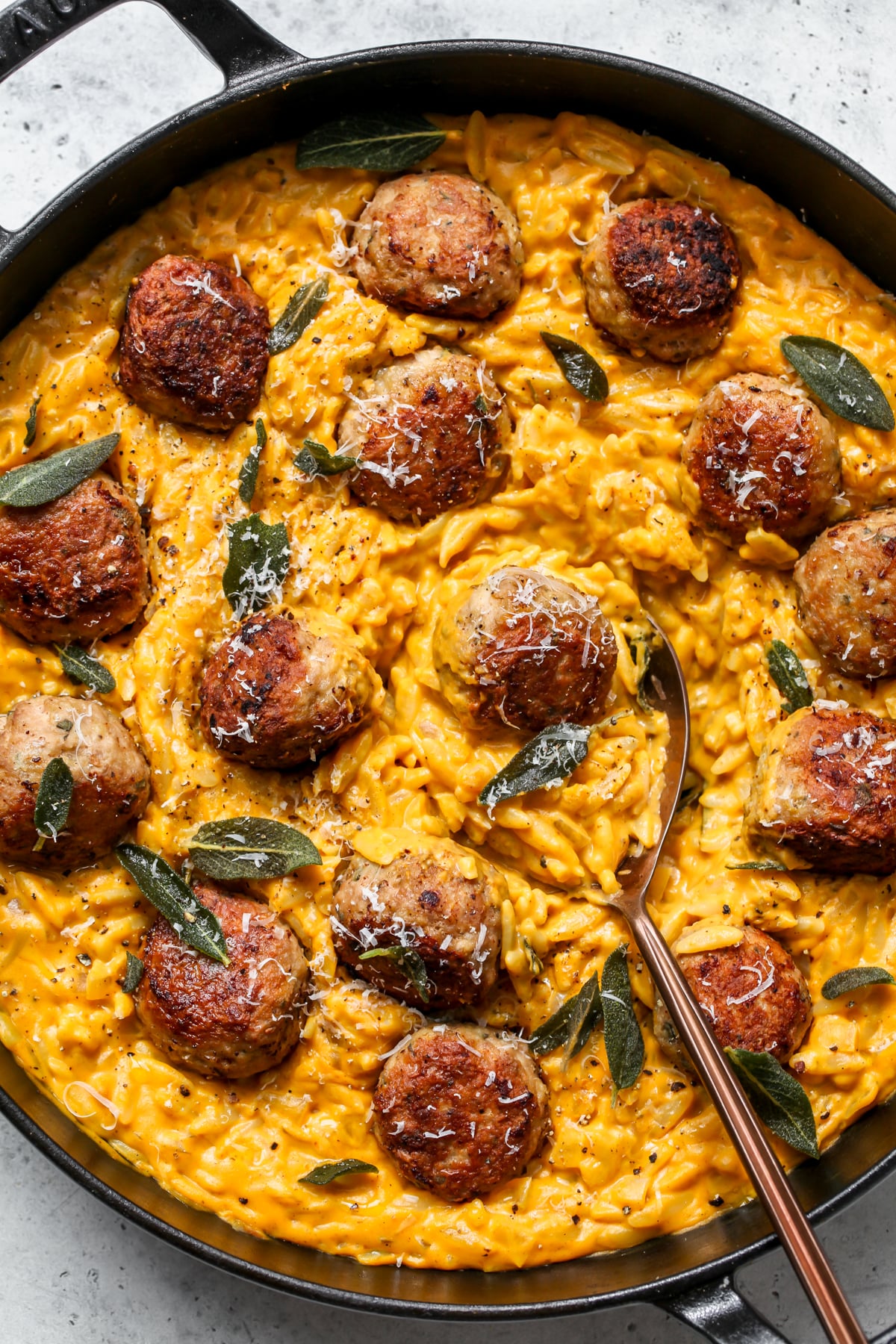 Pumpkin recipes featuring a pot of pumpkin orzo with sage turkey meatballs.