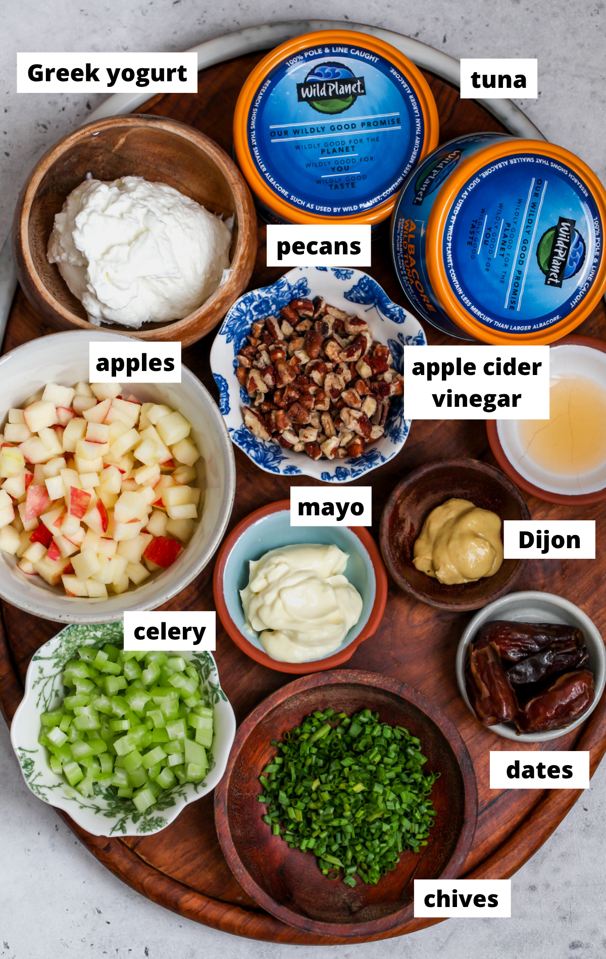 Recipe ingredients arranged on a wooden platter with labels.
