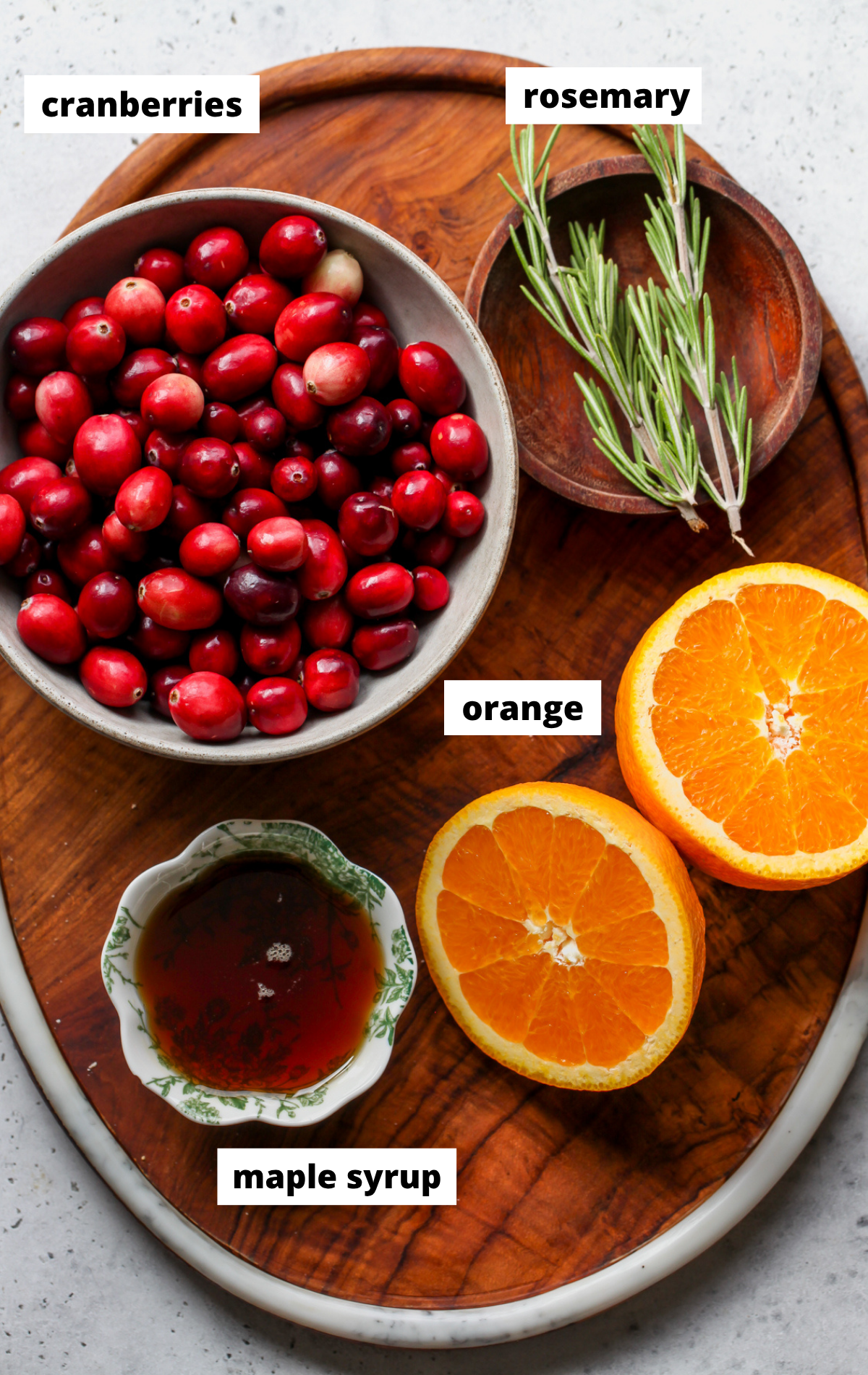 Recipe ingredients in separate bowls arranged on a wooden platter.