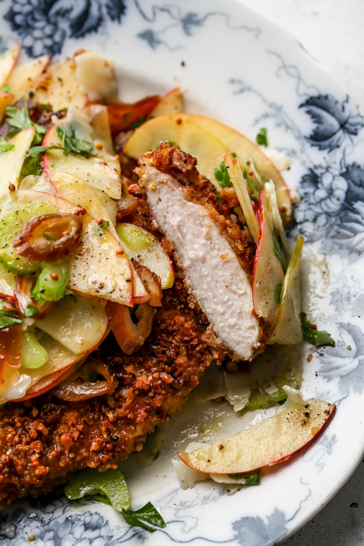 A chicken cutlet being sliced into to show tender texture inside.