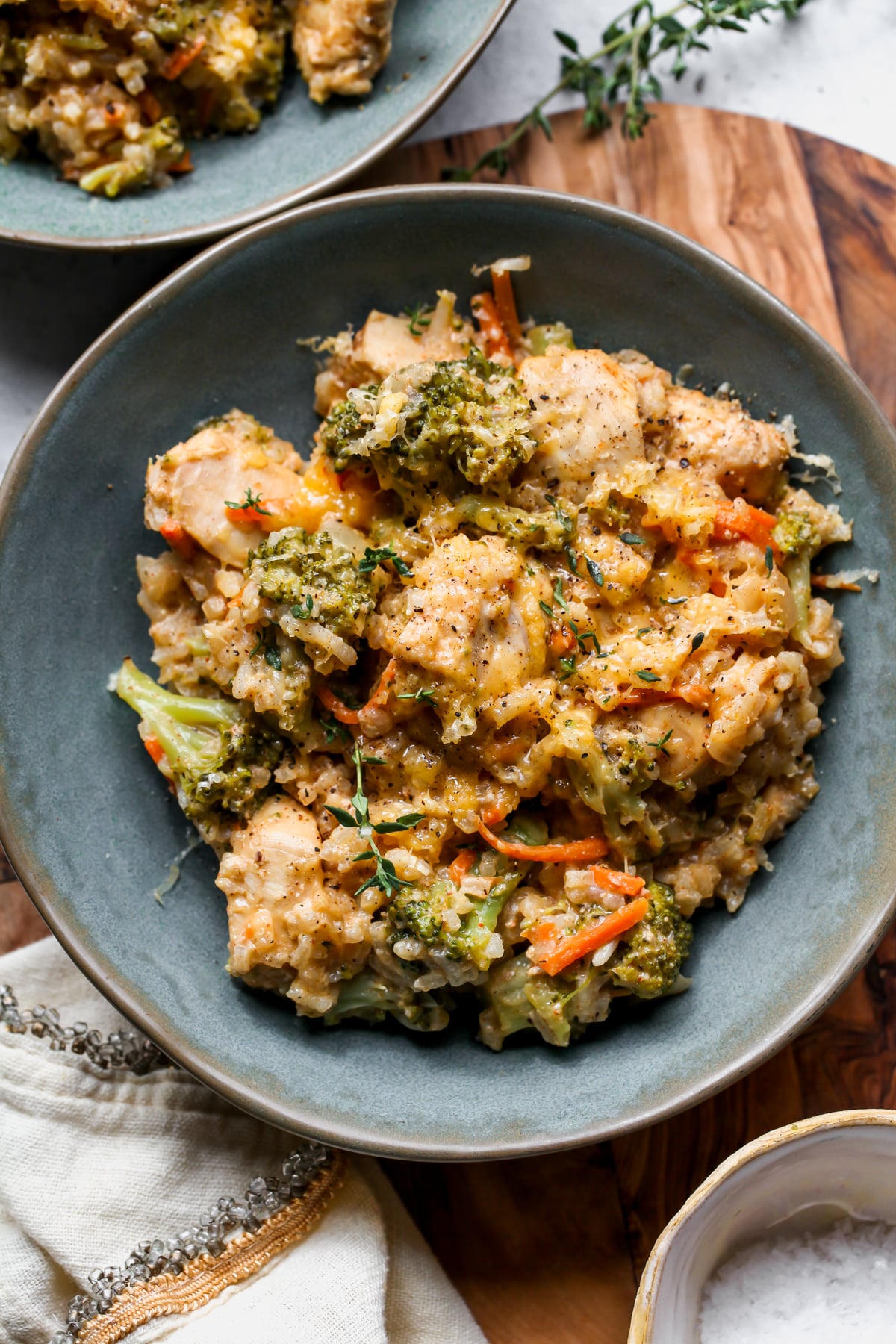 Broccoli-Cheddar Chicken and Rice styled in a teal bowl on a wooden surface.